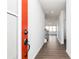 Inviting hallway features hardwood floors, neutral paint and trim, with a view into the sun filled living room at 116 Chattahoochee Cir, Locust Grove, GA 30248