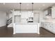 Bright kitchen featuring white cabinets, quartz countertops, island, and stainless appliances at 116 Chattahoochee Cir, Locust Grove, GA 30248