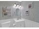 Charming powder room with decorative wallpaper, a stylish vanity, and a round mirror at 3067 Nuptial Ln, Lawrenceville, GA 30044