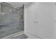 Modern bathroom featuring a glass enclosed shower with horizontal grey tiling and white cabinets at 3067 Nuptial Ln, Lawrenceville, GA 30044