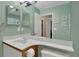 Bright, updated bathroom with light green walls and neutral fixtures at 3067 Nuptial Ln, Lawrenceville, GA 30044
