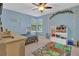 room features playful decor, a whimsical rug, and ample storage for toys and books at 3067 Nuptial Ln, Lawrenceville, GA 30044