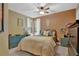 Cozy bedroom features a ceiling fan, natural light, and neutral decor, creating a relaxing atmosphere at 3067 Nuptial Ln, Lawrenceville, GA 30044