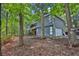Charming two-story home showcasing a side-entry garage surrounded by mature trees and natural landscaping at 3067 Nuptial Ln, Lawrenceville, GA 30044