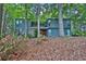 Inviting two-story home with beautiful landscaping and a charming red front door nestled among mature trees at 3067 Nuptial Ln, Lawrenceville, GA 30044