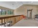 Hallway with railing and sitting area by bright windows at 3067 Nuptial Ln, Lawrenceville, GA 30044