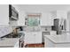 Bright kitchen with white cabinetry, stainless steel appliances, and granite countertops at 3067 Nuptial Ln, Lawrenceville, GA 30044