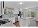 This kitchen showcases new stainless steel appliances, an island, and sliding glass doors to the outdoor patio at 3067 Nuptial Ln, Lawrenceville, GA 30044