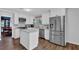 Bright kitchen features white cabinets, stainless steel appliances, and a center island with granite countertops at 3067 Nuptial Ln, Lawrenceville, GA 30044