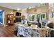 Cozy living room with a stone fireplace, wood floors, and large windows overlooking the backyard at 3067 Nuptial Ln, Lawrenceville, GA 30044