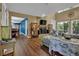 Open living room with a stone fireplace, wood floors, and large windows offering scenic outdoor views at 3067 Nuptial Ln, Lawrenceville, GA 30044