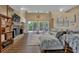 Inviting living room with a stone fireplace, wood floors, and large windows providing backyard views at 3067 Nuptial Ln, Lawrenceville, GA 30044