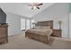 Spacious main bedroom with a large bed, side tables, and plenty of natural light at 3067 Nuptial Ln, Lawrenceville, GA 30044