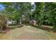 Spacious backyard with green grass, mature trees, and a storage shed at 4074 Idlevale Dr, Tucker, GA 30084