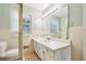 Well-lit bathroom features a shower, window, large mirror and vanity with white countertop at 4074 Idlevale Dr, Tucker, GA 30084