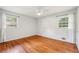Bedroom features hardwood floors, windows, and neutral paint at 4074 Idlevale Dr, Tucker, GA 30084