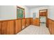 Bright dining room with wood paneling, tile flooring, and a large window offering a pleasant view at 4074 Idlevale Dr, Tucker, GA 30084