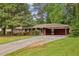 Exterior view of brick home with carport and long driveway at 4074 Idlevale Dr, Tucker, GA 30084