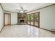 Bright living room features a stone fireplace, tile floors, and access to the backyard at 4074 Idlevale Dr, Tucker, GA 30084