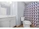 Bathroom with white cabinets and sink, toilet and blue patterned shower curtain at 6297 Polar Fox Ct, Riverdale, GA 30296