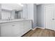 Bathroom featuring double vanity, large mirror and wood floors at 6297 Polar Fox Ct, Riverdale, GA 30296