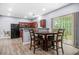 Bright dining area with a table set near a kitchen and sliding door to the backyard at 6297 Polar Fox Ct, Riverdale, GA 30296