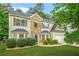 Charming two-story home featuring a well-maintained lawn and manicured shrubbery at 6297 Polar Fox Ct, Riverdale, GA 30296