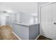 Light filled upstairs hallway with wood floors and neutral paint at 6297 Polar Fox Ct, Riverdale, GA 30296