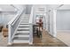 Bright foyer showcasing a staircase and hardwood flooring leading to the upper level at 6297 Polar Fox Ct, Riverdale, GA 30296
