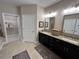 Bathroom showcasing a double vanity with black cabinets and marble countertops at 1001 Calypso Way # 1001, Cumming, GA 30040