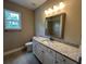 Bathroom showing a granite countertop vanity, large mirror, and a tiled floor at 1001 Calypso Way # 1001, Cumming, GA 30040