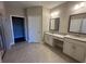 Bright bathroom featuring double vanity with cream cabinets and granite countertops at 1001 Calypso Way # 1001, Cumming, GA 30040