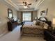 Comfortable bedroom featuring a decorative ceiling, a ceiling fan and large window at 1001 Calypso Way # 1001, Cumming, GA 30040