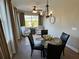 Cozy dining room featuring a chandelier, neutral paint, and a large window at 1001 Calypso Way # 1001, Cumming, GA 30040