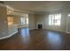 Open concept living area with hardwood floors, fireplace, and ample natural light at 1001 Calypso Way # 1001, Cumming, GA 30040