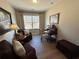 Cozy sitting room showcasing chairs, a desk, and a large window at 1001 Calypso Way # 1001, Cumming, GA 30040