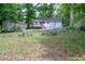 Spacious backyard view with a detached shed and trees surrounding the property at 1025 Cheaves St, Forest Park, GA 30297