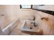 Image of a bathroom featuring a white bathtub, toilet, and sink at 1025 Cheaves St, Forest Park, GA 30297