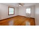 A bright bedroom with hardwood floors, ceiling fan, and natural light from two windows at 1025 Cheaves St, Forest Park, GA 30297