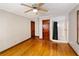 A bright bedroom with hardwood floors, ceiling fan, and ensuite bathroom featuring a shower at 1025 Cheaves St, Forest Park, GA 30297