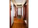 Hallway featuring hardwood floors, doors and a ceiling access panel at 1025 Cheaves St, Forest Park, GA 30297