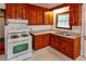 Efficient kitchen featuring wooden cabinetry, gas range, and ample countertop space at 1025 Cheaves St, Forest Park, GA 30297