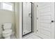 Modern bathroom featuring a glass shower with white marble-style tiles and hexagon floor tiles at 2621 Oldknow Nw Dr, Atlanta, GA 30318