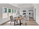 Bright dining area adjacent to a modern kitchen, featuring ample natural light and sleek finishes at 2621 Oldknow Nw Dr, Atlanta, GA 30318