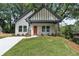 Inviting craftsman home with a bright orange front door, covered porch, and pristine landscaping at 2621 Oldknow Nw Dr, Atlanta, GA 30318