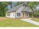 Charming craftsman-style home featuring a well-manicured lawn and inviting front porch at 2621 Oldknow Nw Dr, Atlanta, GA 30318