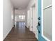 Inviting entryway with wood flooring, light gray walls, and a view of the open-concept living space at 509 Altamaha Ct, Locust Grove, GA 30248