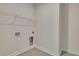 Practical laundry room with shelving, washer hookups, and a clean, functional design at 509 Altamaha Ct, Locust Grove, GA 30248