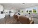 Open-concept kitchen, living, and dining area with modern finishes and an abundance of natural light at 509 Altamaha Ct, Locust Grove, GA 30248