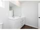 Bathroom featuring a double sink vanity, a large mirror, and modern fixtures at 736 Ocmulgee Xing, Locust Grove, GA 30248